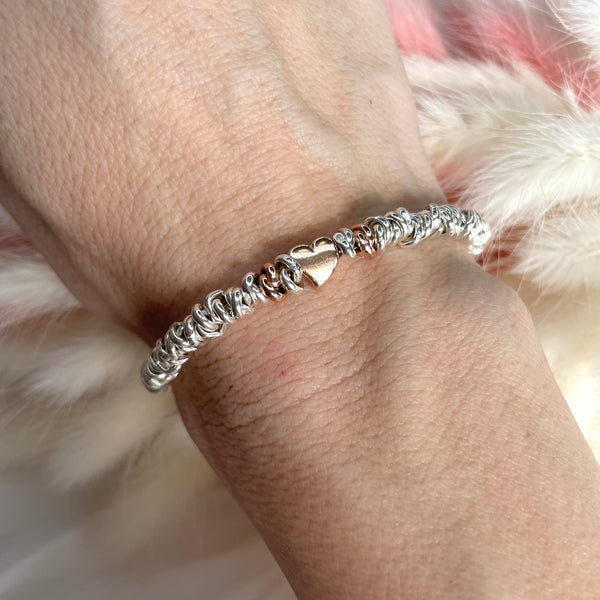 B127 Bracelet with knots and pink heart passing through the center