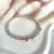 B127 Bracelet with knots and pink heart passing through the center