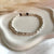 B0302 Bracciale con rondelle irregolari martellate piccole lisce
