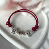 B144 Bracciale con elementi passanti bimbi cordino cerato con granelli nuovi e iniziali