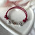 B144 Bracciale con elementi passanti bimbi cordino cerato con granelli nuovi e iniziali
