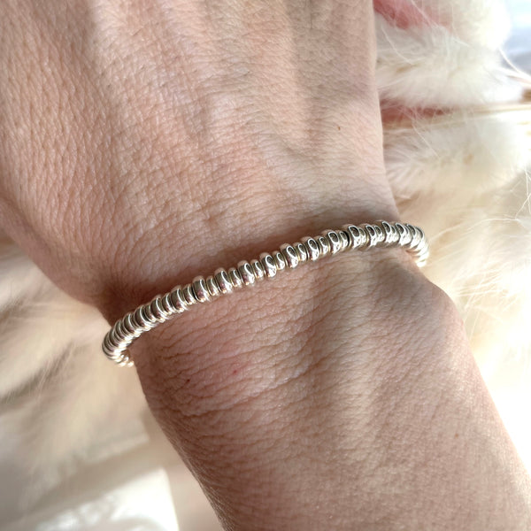 B058 Bracciale con rondelle medie e piccole alternate