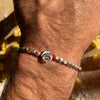 B113 Bracciale unisex con pepite martellate e Tortellino passante