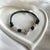 B0249 Bracciale cordino cerato e rondelle con elementi passanti bimbi e volendo iniziali