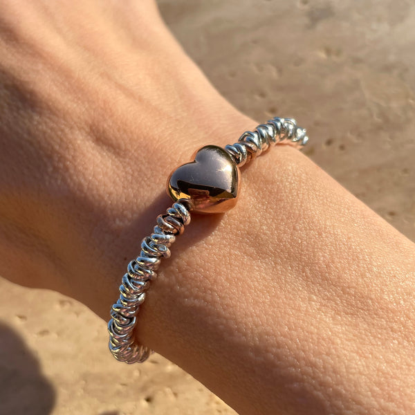 B118 Bracciale con cuore bomby rosato, argentato o dorato al centro e nodini argento