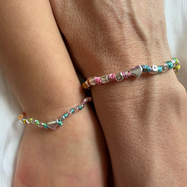 B067 Mother and daughter bracelet with hammered nuggets and central heart interspersed with knots