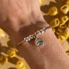B114 Bracciale rigido con Tortellino pendente