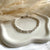 B0302 Bracciale con rondelle irregolari martellate piccole lisce