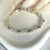 B048 Bracciali con sassi grandi lisci, palline e rondelle fiore