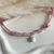 CL0174 Collana con cordino cerato con granelli e fiore pendente “grazie maestra”