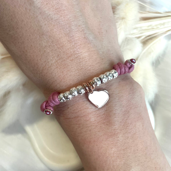 B133 Bracciale con cordino cerato, granelli nuovi, rondelle rosate + ciondolo al centro (a scelta da scegliere)