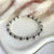 B084 Bracciale con rondelle ematite intervallate a rondelle piccole e medie