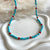 CL0180 Collana con cubetti di aulite sfaccettata, corallo e rondelle argento.
