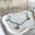 CL0181 Collana rosario in pasta di turchese e ciondoli: pesce, barca e conchiglia