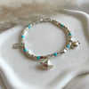 B0289 Bracciale con cubetti, palline pasta di turchese e ciondoli: pesce, barca e conchiglia