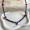 CL0179 Collana con cubetti di lapislazzuli sfaccettato, corallo e occhio turco portafortuna pendente