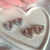 O011 Orecchini con cuore argentato o rosato con zirconi
