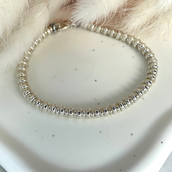 B058 Bracciale con rondelle medie e piccole alternate