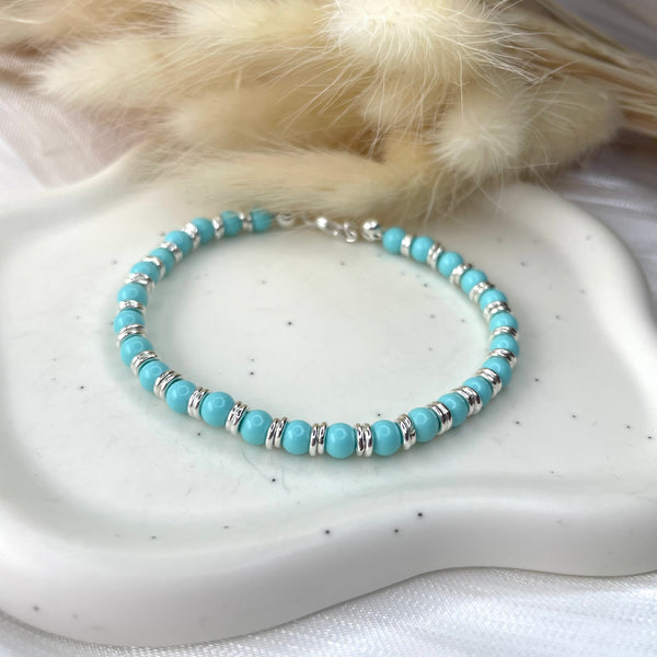 B086 Bracelet with turquoise paste balls interspersed with two small rings