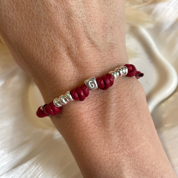 B0228 Bracciale con cordino cerato, rondelle + ciondolo al centro (a scelta da opzionare)