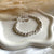 B0301 Bracciale con rondelle irregolari martellate grandi e piccole
