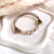 B0299 Bracciale in cordino cerato di coppia con puzzle, iniziali cubo e granelli
