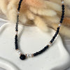 CL024 Collana con pietra del sole blu, perle, rondelle rosate e goccia in onice
