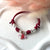 B036 Bracciale con 4 nodi di cordino cerato, 8 granelli nuovi, 2 rondelle rosate + ciondolo a scelta (a parte)