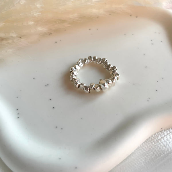 A023 Anello elasticizzato con rondelle irregolari martellate