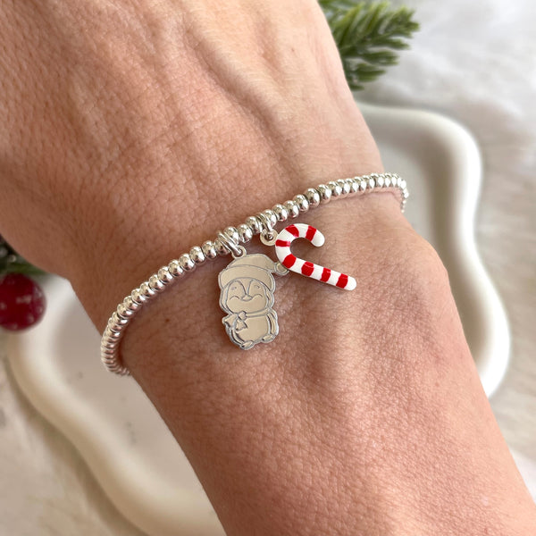 B0227 Bracciale rondelline con pinguino e bastoncino di zucchero