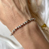 B0168 Bracciale palline piccole con cuori passanti rosati