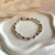B0305 Bracciale con rondelle irregolari martellate piccole martellate e nodi in filo nautico