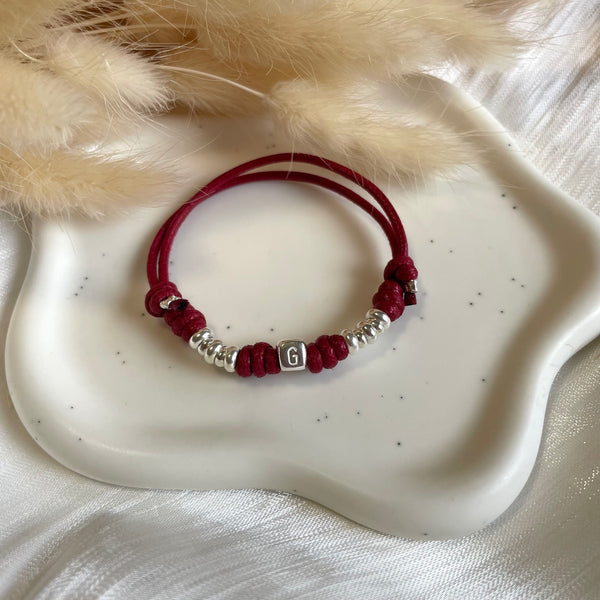 B0228 Bracciale con cordino cerato, rondelle + ciondolo al centro (a scelta da opzionare)