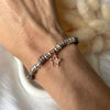 B169 Bracciale con cordino cerato, rondelle + ciondolo al centro (a scelta)
