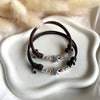 B0244 Bracciale in cordino cerato con puzzle e rondelle