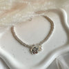 B0279 Bracciale con rondelline piccole, perla e fiore pendente “grazie maestra”