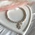 B0265 Bracciale con palline, orsettino con cuore e perlina pendenti