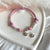 B0270 Bracciale in cordino cerato con granelli e cuore pendente