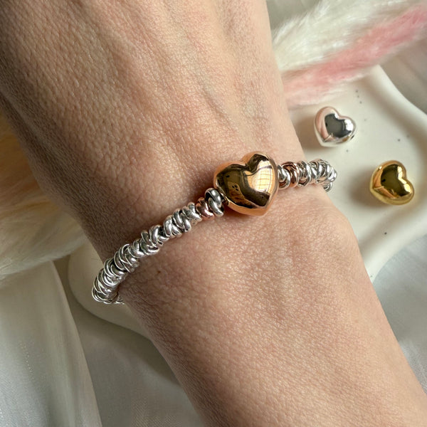 B118 Bracciale con cuore bomby rosato, argentato o dorato al centro e nodini argento