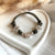 B0200 Bracciale con elementi passanti bimbi e casina Family, cordino cerato e granelli