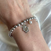 B0265 Bracciale con palline, orsettino con cuore e perlina pendenti