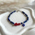 B0288 Bracciale con cubetti di lapislazzuli sfaccettati, corallo e occhio turco portafortuna