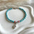 B0284 Bracciale con rondelle sfaccettate in aulite, argento e ciondolo conchiglia.