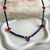 CL0179 Collana con cubetti di lapislazzuli sfaccettato, corallo e occhio turco portafortuna pendente