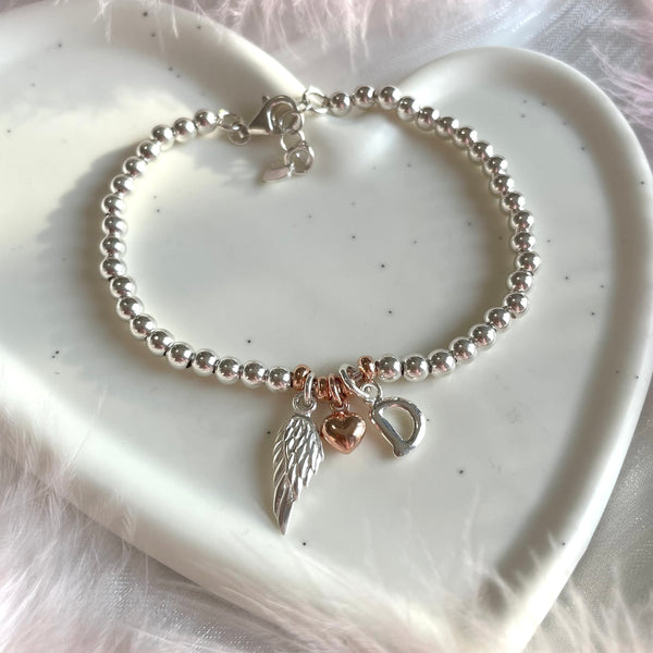 B0203 Bracciale madrina con palline, ala d’angelo e iniziale (facoltativa)