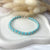 B086 Bracciale con palline in pasta di turchese intervallata da due anelline