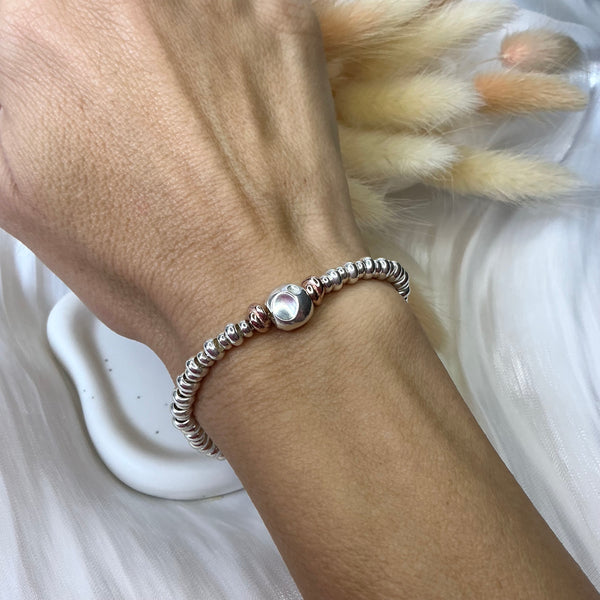 B0183 Bracciale con rondelle e pepitone al centro