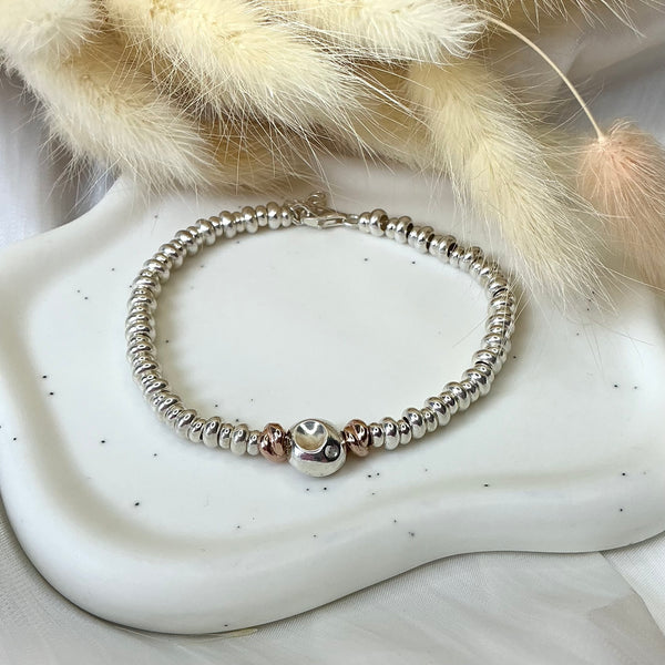 B0183 Bracciale con rondelle e pepitone al centro