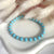 B093 Bracciale con palline turchesi e anelline