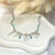 CL099 Collana rosario pasta di turchese con multiciondoli tema mare